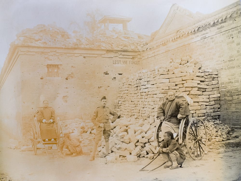 A ruined corner of the British Legation, Peking (Beijing), c.1901, with LEST WE FORGET inscribed on the wall. Photograph by the Photo Section of the British Corps of Royal Engineers, from an album (WO 28/302. China. Boxer Rebellion) in the National Archives. Crown copyright image reproduced by permission of The National Archives, London, England.