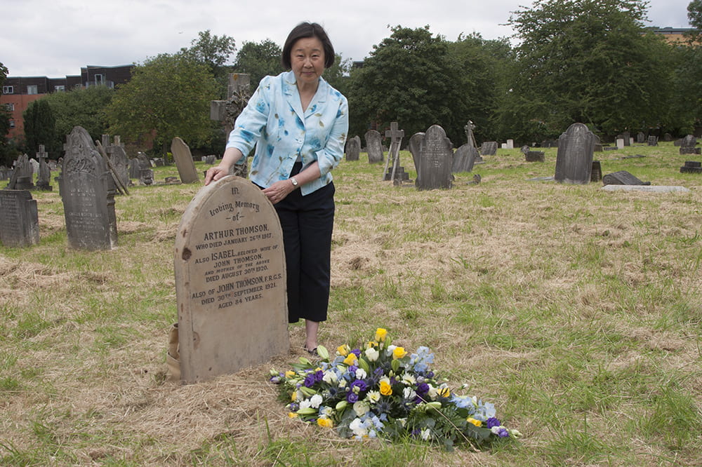 Betty Yao MBE beside John Thomson’s restored grave, Streatham Cemetery, Tooting, London, 13 July 2019. Photograph by Jamie Carstairs.