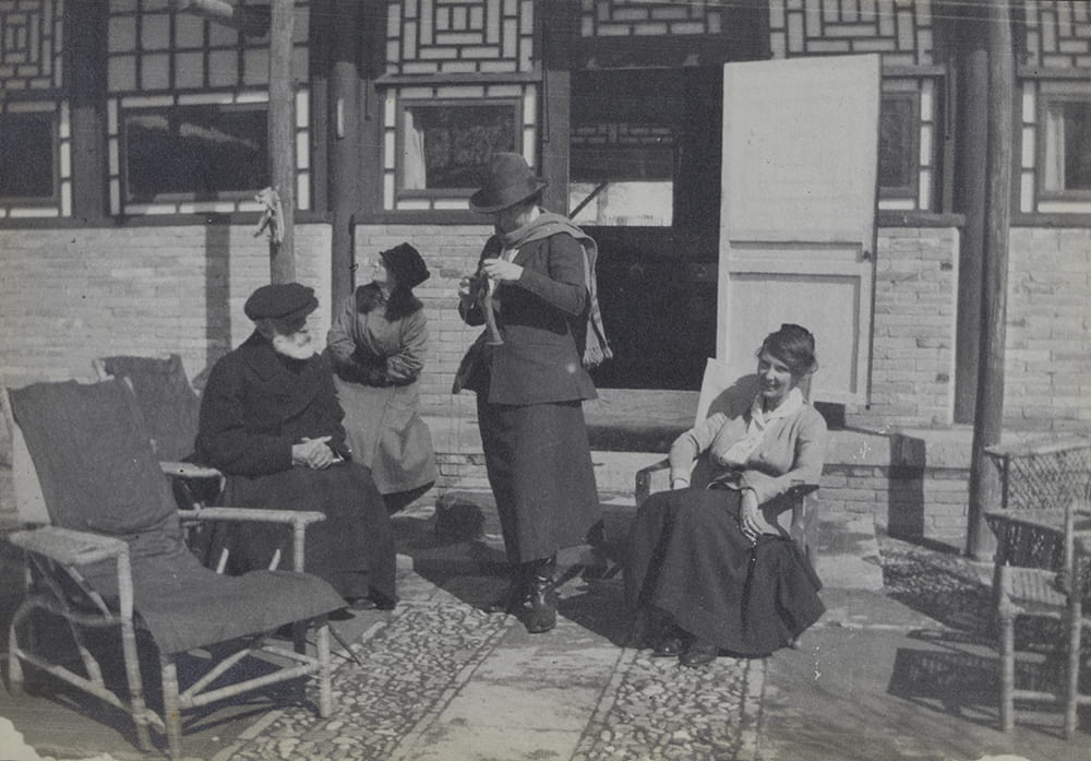 ‘Sitting out in sun in time of snow’ at Balizhuang. From left, Guy, Hatty B., Flo (Florence Harding, Ella’s sister) and Ella. HPC ref: EH01-289.